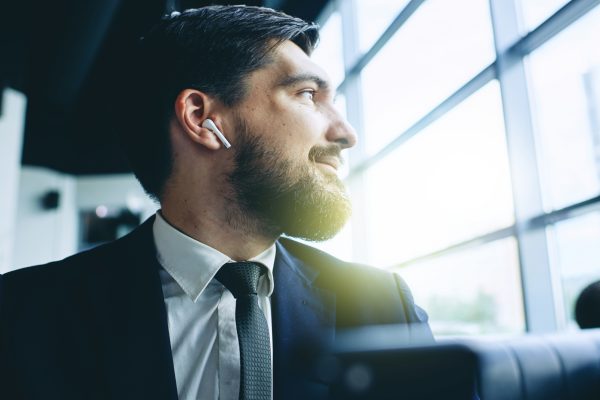 business man listening to finance podcasts